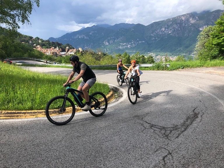 Cyclists on a Curved Road Near Lake Como