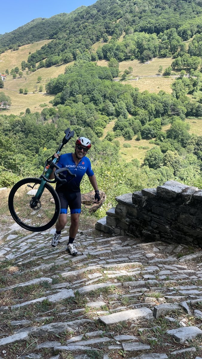 Cyclist Carrying Bike Uphill