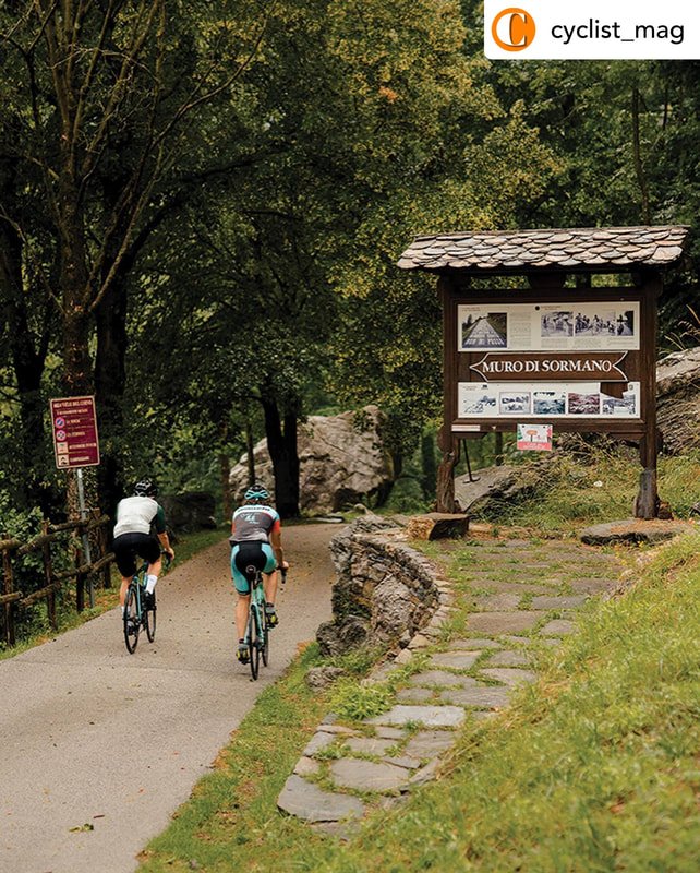 Two cyclists on a winding road in the mountains Two cyclists on a winding road in the mountains